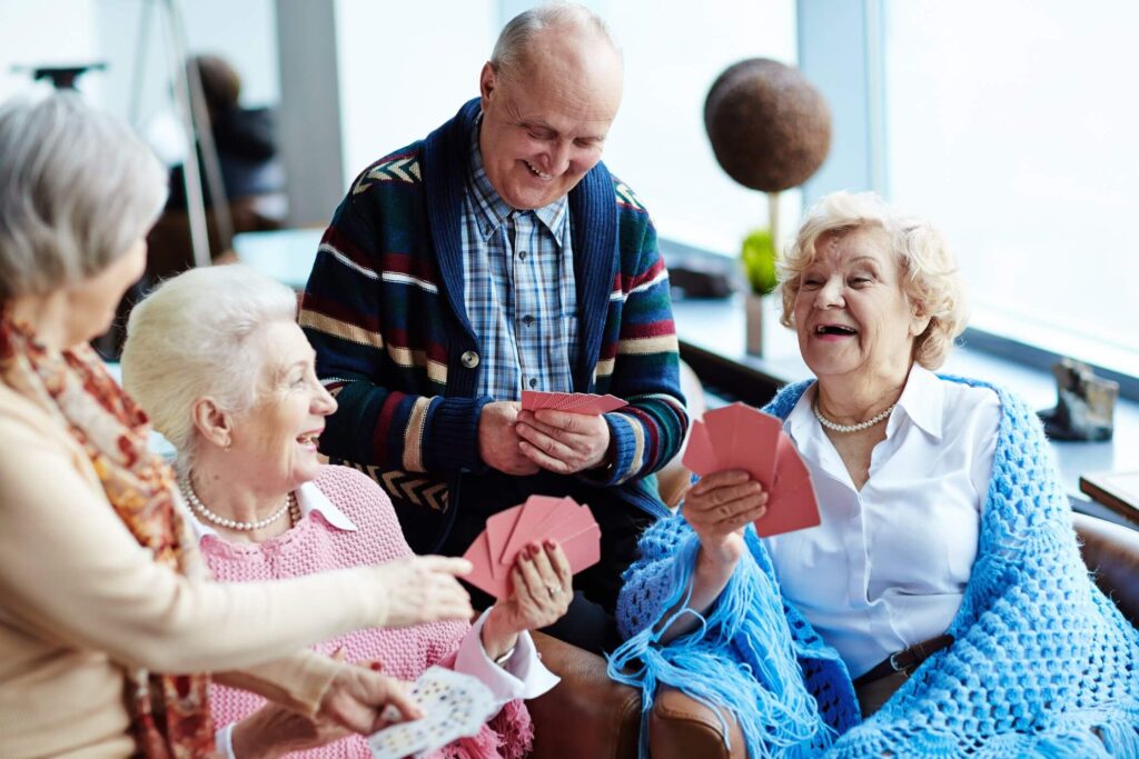 Elderly playing cards happy senior living